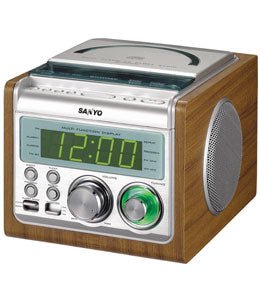 A Sanyo RM-XCD900 dual alarm clock radio CD player with a digital display showing the time