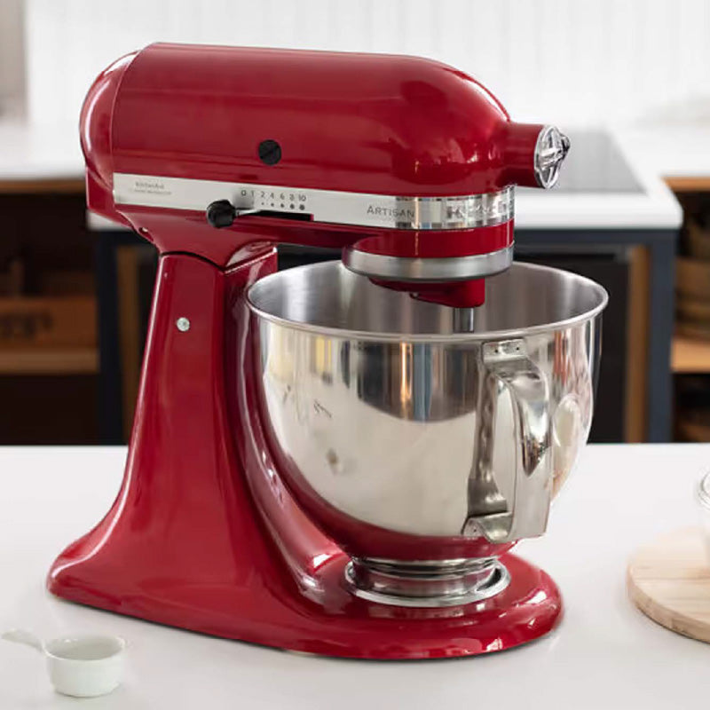 Red stand mixer with a silver bowl on a kitchen counter.