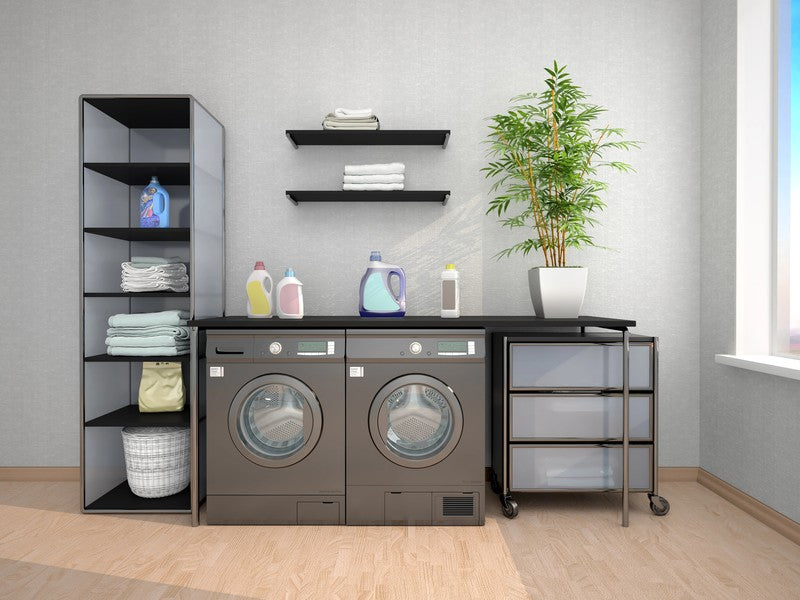 Laundry room with washing machines and shelves.