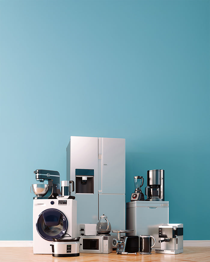 Home appliances on a wooden surface with a blue wall background.