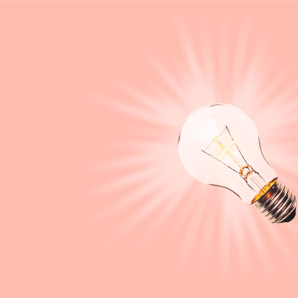 Light bulb on a peach background