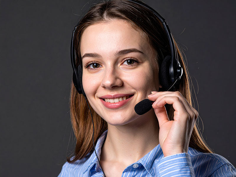 Woman wearing a headset with a dark background